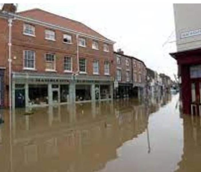 Flooded street with businesses 
